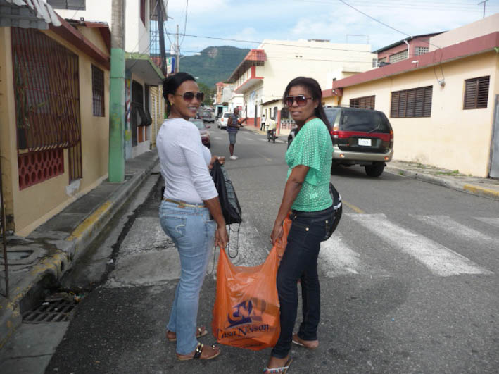 Tania and Digna carrying schoolsupplies to orphanage